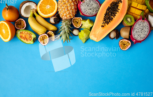 Image of different exotic fruits on blue background