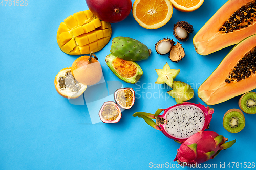 Image of different exotic fruits on blue background