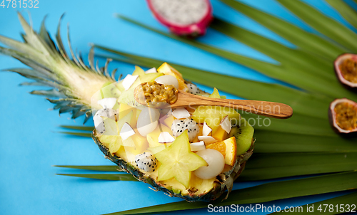 Image of mix of exotic fruits in pineapple with spoon