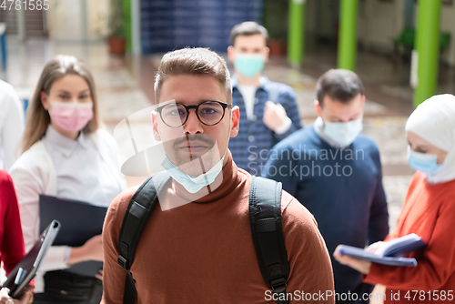 Image of Portrait of multiethnic students group at university wearing protective face mask