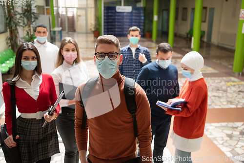 Image of Portrait of multiethnic students group at university wearing protective face mask