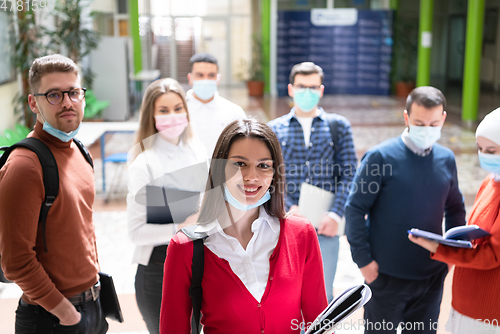 Image of Portrait of multiethnic students group at university wearing protective face mask