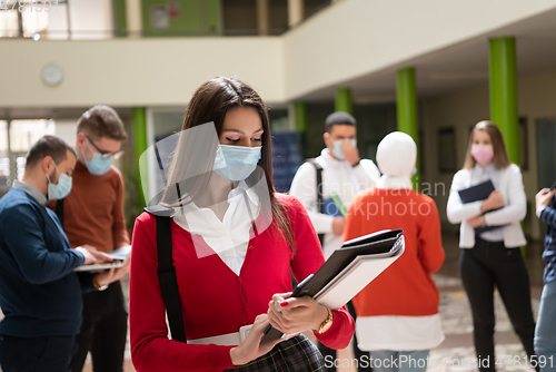 Image of Portrait of multiethnic students group at university wearing protective face mask