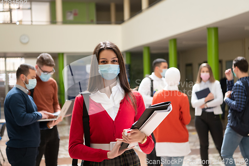 Image of Portrait of multiethnic students group at university wearing protective face mask