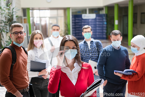 Image of Portrait of multiethnic students group at university wearing protective face mask