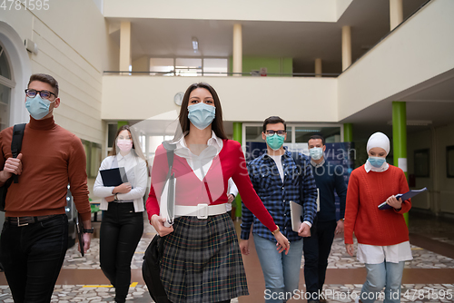 Image of students group at university walking and wearing face mask