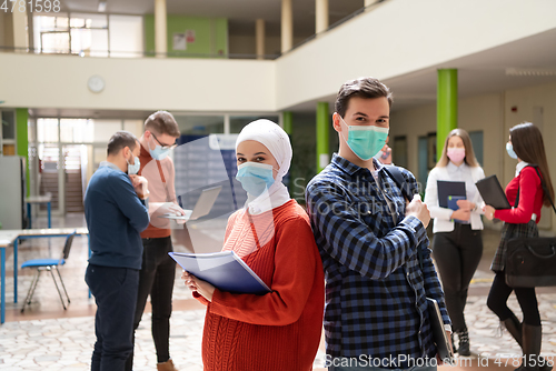 Image of Portrait of multiethnic students group at university wearing protective face mask