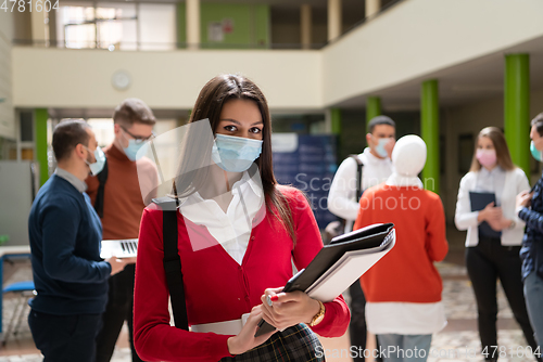 Image of Portrait of multiethnic students group at university wearing protective face mask