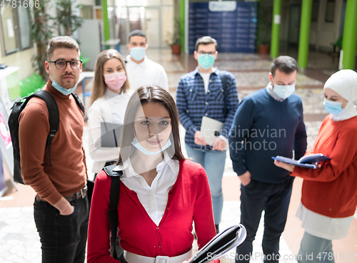 Image of Portrait of multiethnic students group at university wearing protective face mask