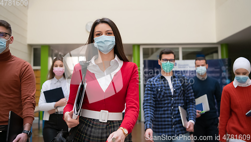 Image of students group at university walking and wearing face mask