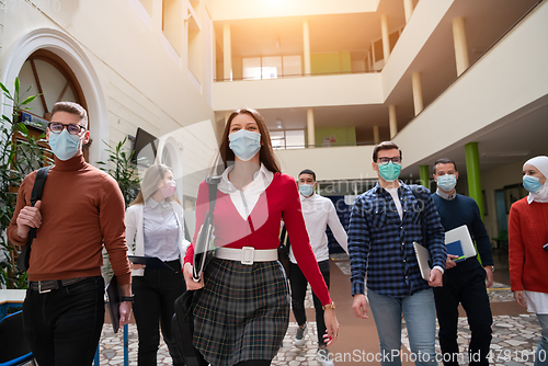 Image of students group at university walking and wearing face mask