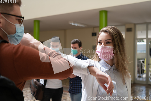 Image of students greeting new normal coronavirus handshake and elbow bumping