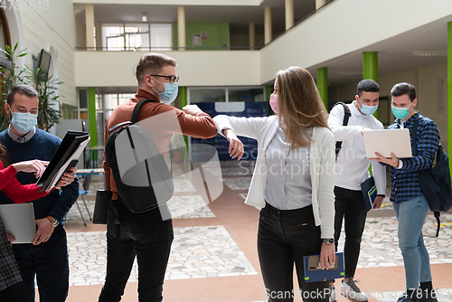 Image of students greeting new normal coronavirus handshake and elbow bumping