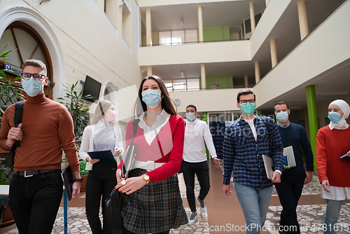 Image of students group at university walking and wearing face mask