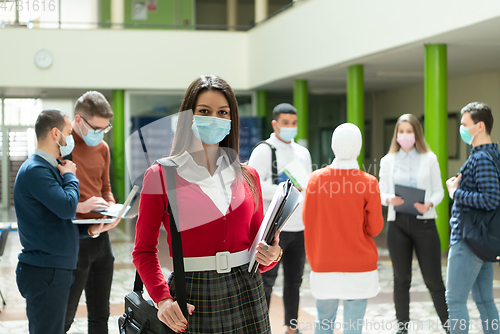 Image of Portrait of multiethnic students group at university wearing protective face mask