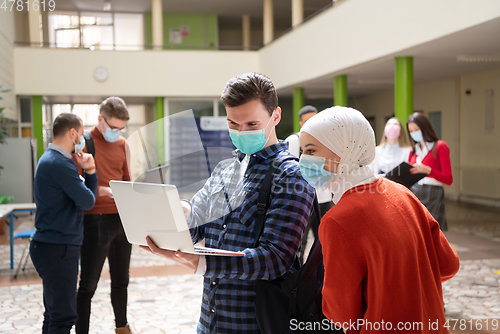 Image of Portrait of multiethnic students group at university wearing protective face mask