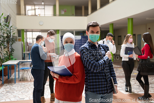 Image of Portrait of multiethnic students group at university wearing protective face mask