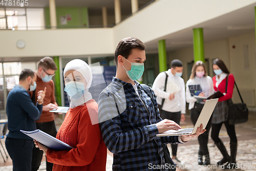 Image of Portrait of multiethnic students group at university wearing protective face mask