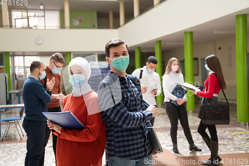 Image of Portrait of multiethnic students group at university wearing protective face mask