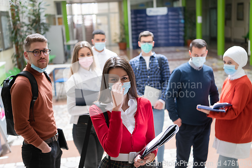 Image of Portrait of multiethnic students group at university wearing protective face mask