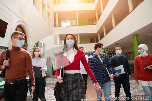 Image of students group at university walking and wearing face mask