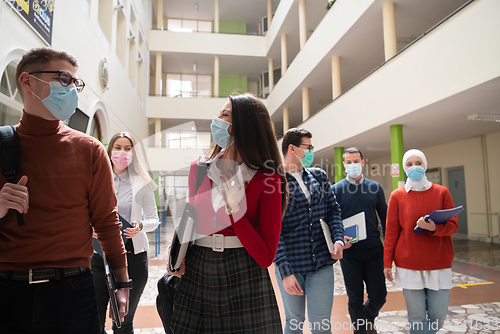 Image of students group at university walking and wearing face mask