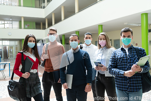 Image of Multiethnic students group wearing protective face mask