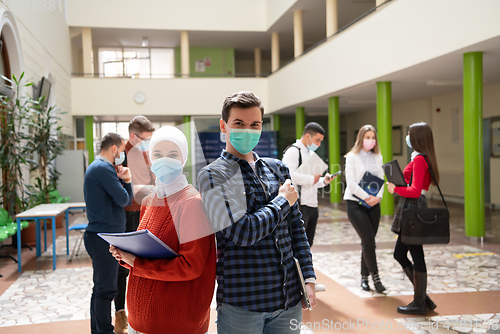 Image of Portrait of multiethnic students group at university wearing protective face mask