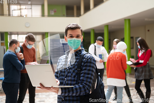 Image of Portrait of multiethnic students group at university wearing protective face mask