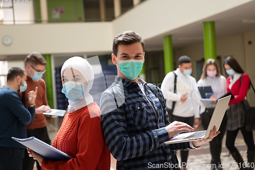 Image of Portrait of multiethnic students group at university wearing protective face mask