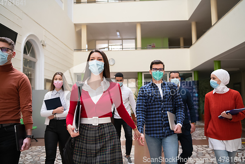 Image of students group at university walking and wearing face mask