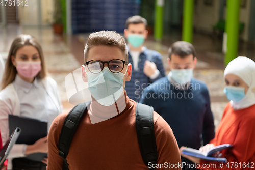 Image of Portrait of multiethnic students group at university wearing protective face mask