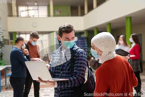 Image of Portrait of multiethnic students group at university wearing protective face mask