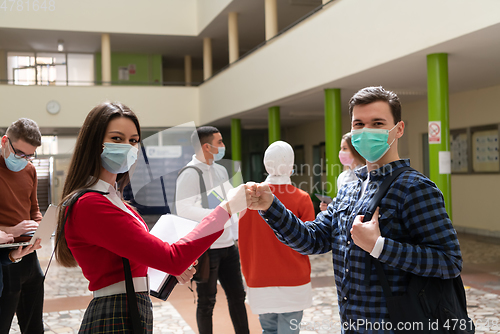 Image of students greeting new normal coronavirus handshake and elbow bumping