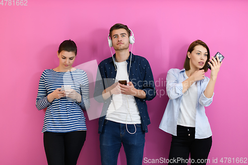 Image of group of friends have fun and dance while using a cell phone and headphones