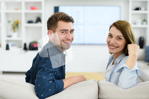 Image of a young married couple enjoys sitting in the large living room