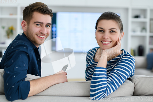 Image of a young married couple enjoys sitting in the large living room