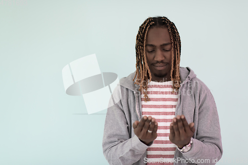 Image of Young African Muslim Man Making Traditional Fatiha Prayer To Allah