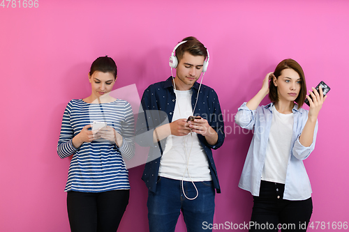 Image of group of friends have fun and dance while using a cell phone and headphones