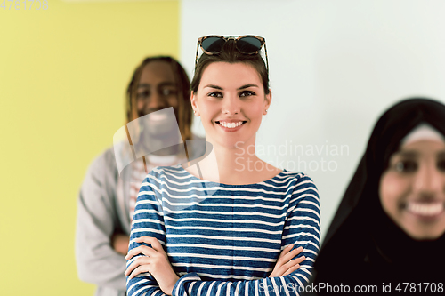 Image of group of diverse teenagers posing in a studio, determined teenagers in diverse clothing.