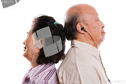 Image of Senior asian couple listening to music