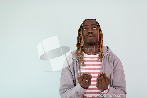 Image of Young African Muslim Man Making Traditional Fatiha Prayer To Allah