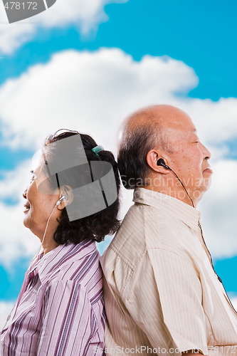 Image of Senior asian couple listening to music