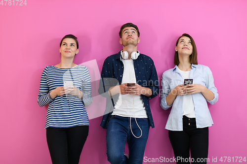 Image of group of friends have fun and dance while using a cell phone and headphones