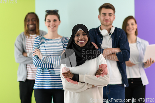 Image of group of diverse teenagers posing in a studio, determined teenagers in diverse clothing.