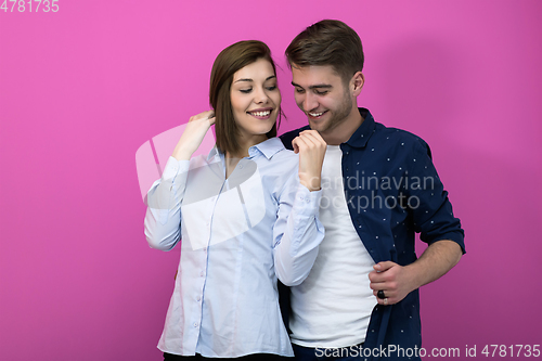 Image of couple dancing in front of a pink background