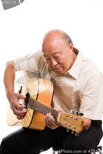 Image of Senior asian playing guitar