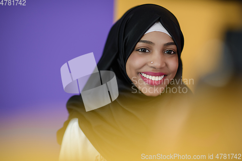 Image of muslim woman with a beautiful smile wearing a hijab poses in the studio