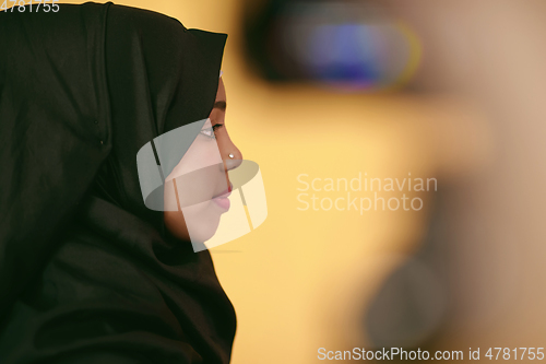 Image of muslim woman with a beautiful smile wearing a hijab poses in the studio