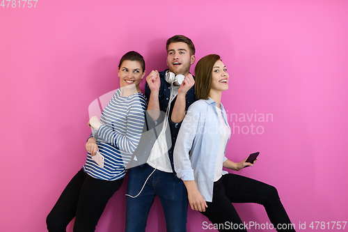 Image of group of friends have fun and dance while using a cell phone and headphones